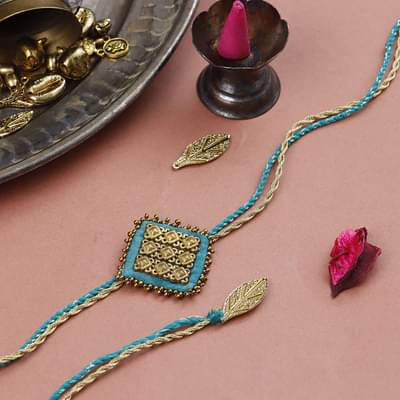 Label Muslin Peacock - Majestic Sqaure Brass Rakhi - Blue image